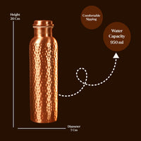 Copper water bottle with measurements and features on a dark background