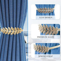 Gold leaf design curtain tieback with text on blue curtains