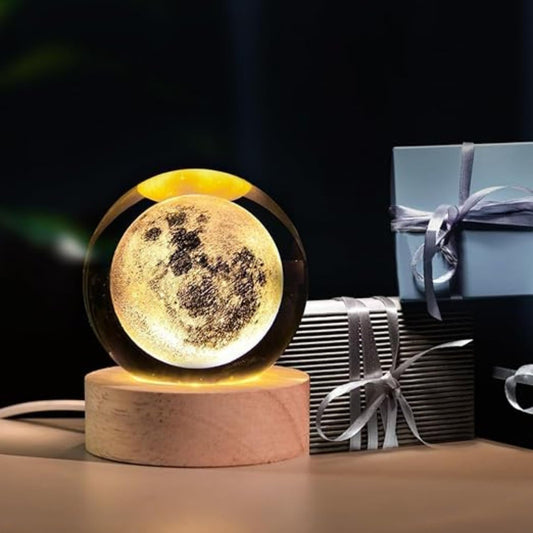 Moon lamp on a wooden base with gift boxes in the background