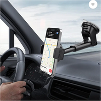 Phone mounted on a car dashboard with a clear view of the road