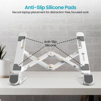 White laptop stand with anti-slip silicone pads on a desk, featuring text about its benefits.