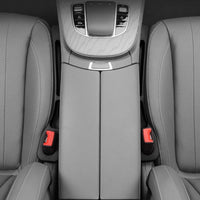 Gray car seat with central armrest and controls
